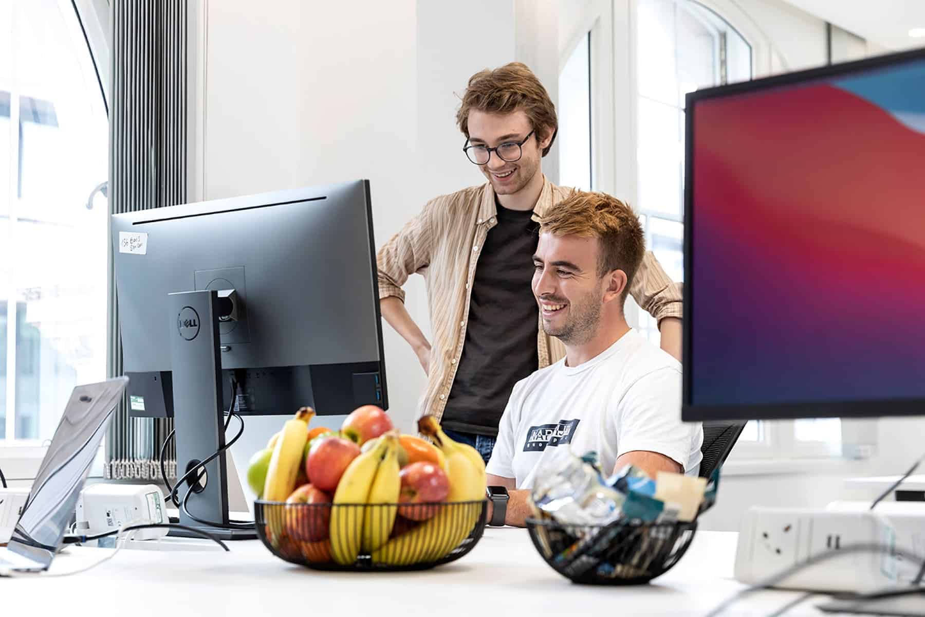 Two colleagues working together in modern office workspace