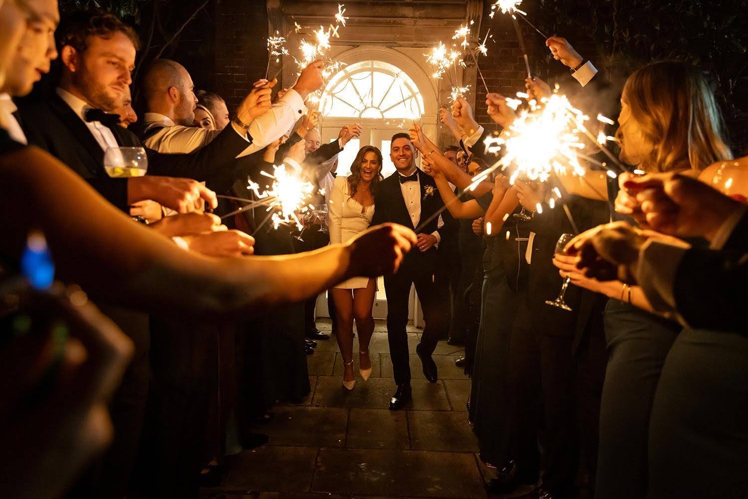 Couple celebrating wedding with sparklers